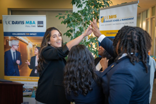 Students high-fiving each other