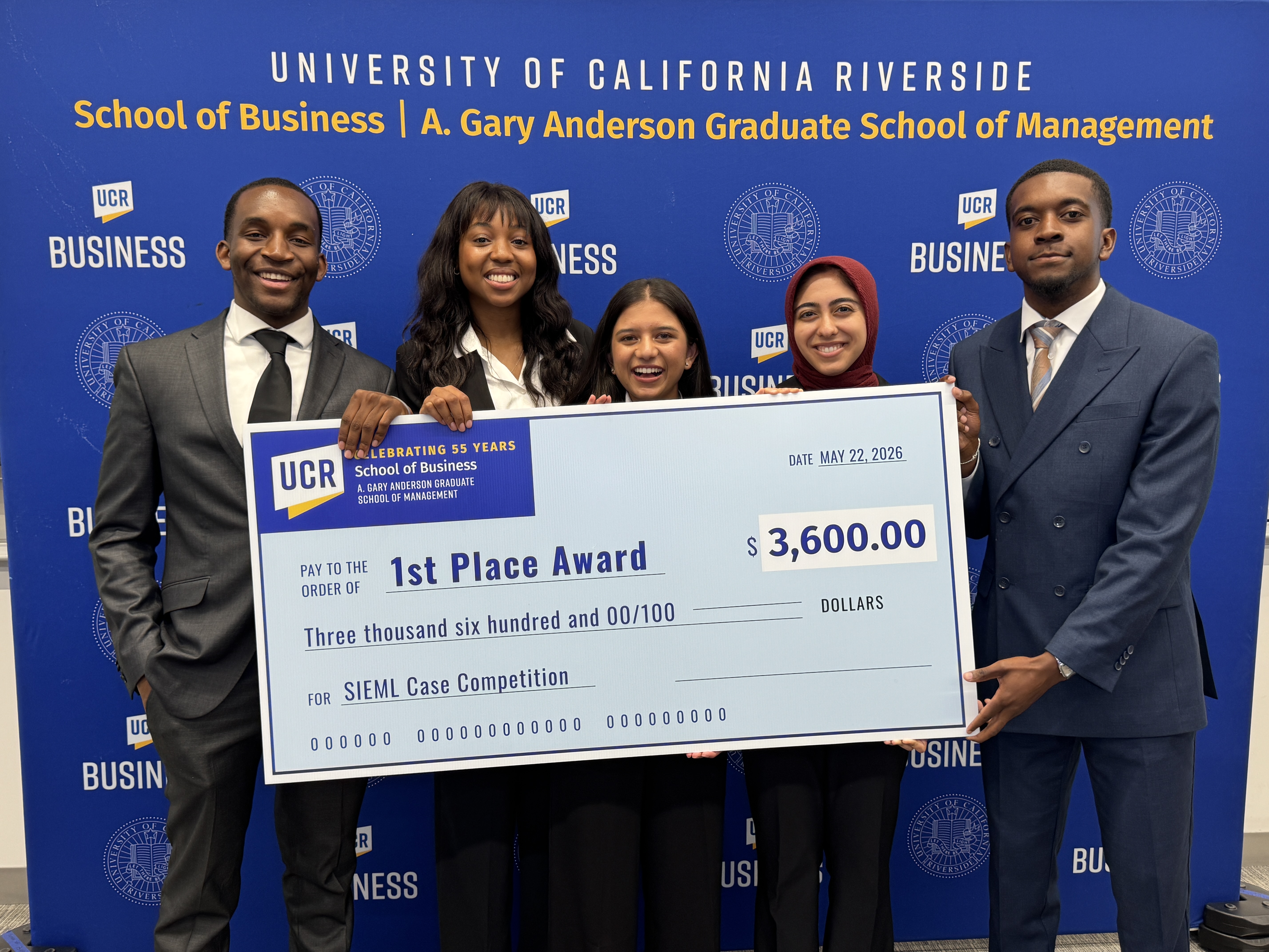 Five students from schools nationwide holding a giant first place check
