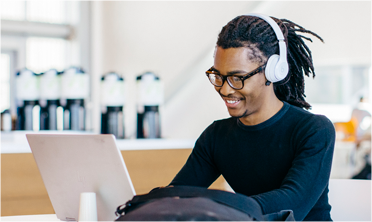 Man using computer with headphones